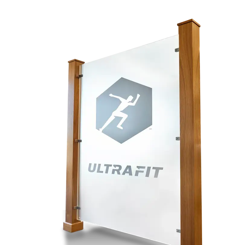 A sign advertising a company called ULTRAFIT mounted on wooden posts.